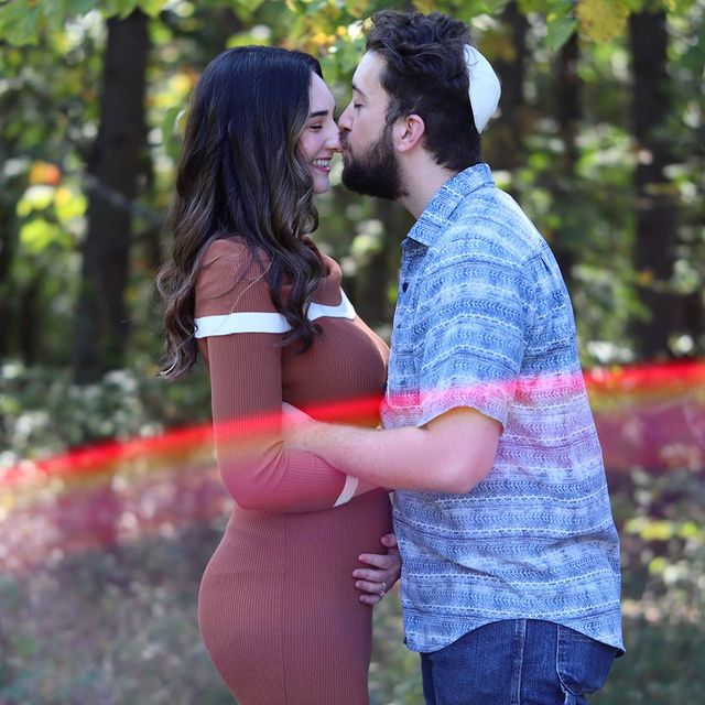Jacob Roth kissing Abby on her nose showing off her baby bump